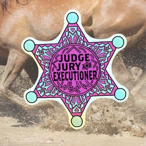 May include: A pink and blue star-shaped badge with the text "JUDGE JURY AND EXECUTIONER" in a black circle in the centre. The badge is on a brown and pink background.