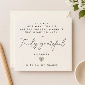 May include: A cream-coloured thank you card with the text "It's not just what you did, but the thought behind it that means so much. I'm Truly grateful, Elizabeth, with all my thanks." A small, sparkly heart is at the bottom.
