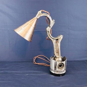 Automotive piston and connecting rod lamp
