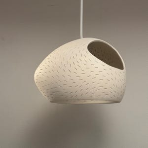 Claylight Pendant 12in. White Ceramic handmade perforated pendant light that casts light textures on ceiling and walls. UL listed Kitchen island light, by lightexture