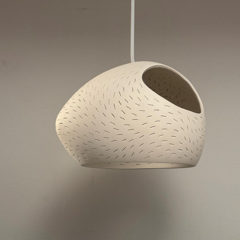 Claylight Pendant 12in. White Ceramic handmade perforated pendant light that casts light textures on ceiling and walls. UL listed Kitchen island light, by lightexture