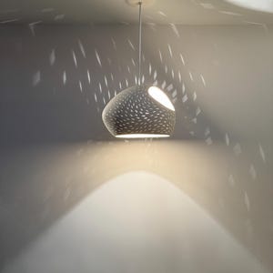 Claylight Pendant 12in. White Ceramic handmade perforated pendant light that casts light textures on ceiling and walls. UL listed Kitchen island light, by lightexture