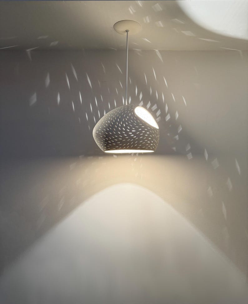Claylight Pendant 12in. White Ceramic handmade perforated pendant light that casts light textures on ceiling and walls. UL listed Kitchen island light, by lightexture