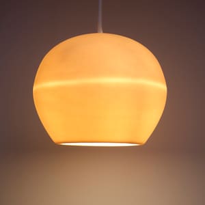 This up close product shot highlights the warm amber-hued glow of this hanging pendant when it is on. The soft and warm magical glow is the antidote to the harsh lighting we are often exposed to at work and school. Like a good song, it hits different