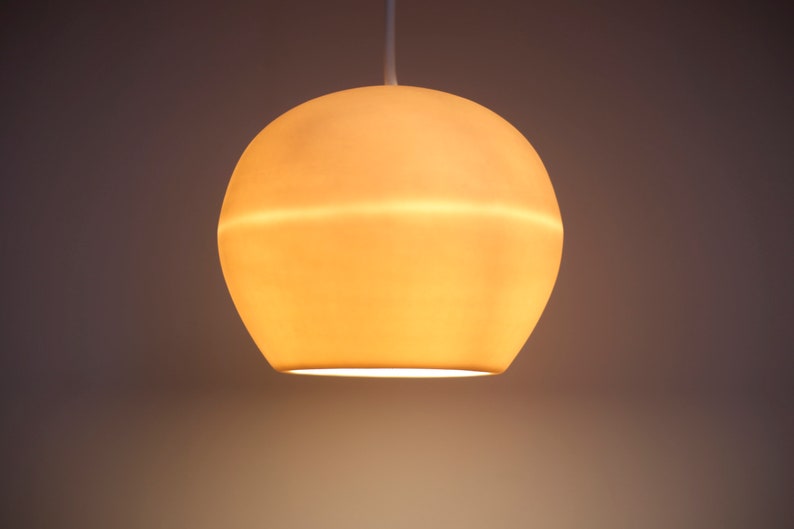 This up close product shot highlights the warm amber-hued glow of this hanging pendant when it is on. The soft and warm magical glow is the antidote to the harsh lighting we are often exposed to at work and school. Like a good song, it hits different