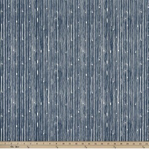 May include: A close-up of a fabric with a repeating pattern of vertical white lines on a dark blue background. The fabric has a textured surface.