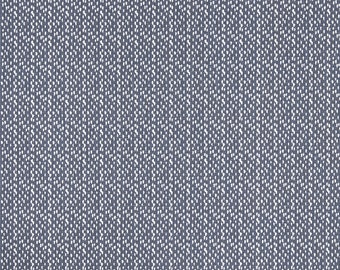 May include: A close-up of a blue fabric with a white speckled pattern. The fabric has a subtle texture and a slightly faded look.