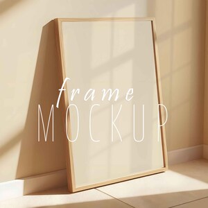 May include: A light wood frame mockup with a blank white canvas. The frame is standing on a light brown surface with a white baseboard.