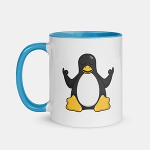 May include: White ceramic coffee mug with a blue rim. The mug features a cartoon penguin in a yoga pose with its eyes closed.