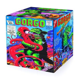 May include: A cubic decorative box featuring vibrant comic book cover art of the monster Gorgo. The front panel depicts a green creature battling a red octopus-like beast with the text GORGO and THE DAY MANHATTAN DIED. The side shows an underwater scene.