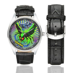 May include: A wristwatch with a black leather strap and a silver case. The watch face displays a green insect with red eyes and a blue car against a colourful radial background. The text "The Green Hornet" is also visible on the watch face.
