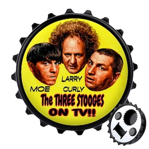May include: Black bottle cap featuring Moe, Larry, and Curly from The Three Stooges on a yellow background. The text "The Three Stooges ON TV!!" is displayed. A separate bottle opener is visible.