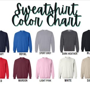 May include: A color chart displaying ten crewneck sweatshirts in various colors. The colors include navy, royal blue, sport grey, dark heather, black, red, maroon, light pink, white, and sand. The text "Sweatshirt Color Chart" is at the top.