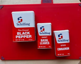 3 empty Schilling spice cans.