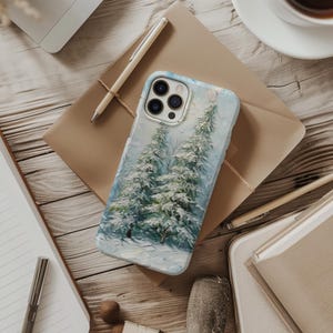 May include: A smartphone case featuring an oil painting style depiction of snow-covered evergreen trees in a winter forest. The design uses textured brushstrokes in shades of white, light blue, and green, with a cutout for a triple-lens camera system.