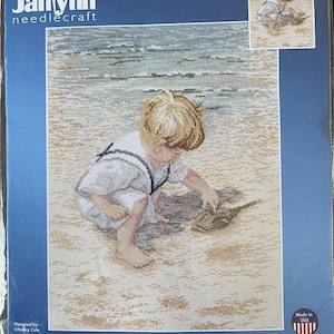 May include: A Janlynn needlecraft kit with a counted cross-stitch design of a boy on a beach with a horseshoe crab. The design size is 30.48 cm x 40.64 cm. The kit includes Aida fabric, cotton floss, a needle, a graph, and instructions.
