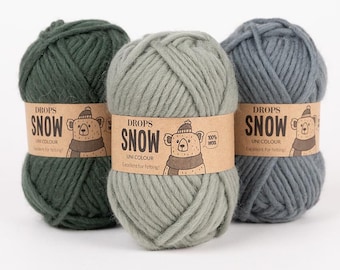 May include: Three balls of Drops Snow yarn in shades of green and gray. Each ball is wrapped with a brown paper label featuring a bear illustration and the text "DROPS SNOW UNI COLOUR Excellent for felting! 100% Wool."