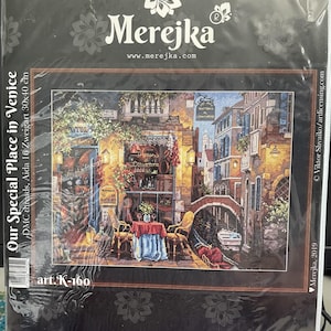 May include: Cross-stitch kit depicting a Venetian scene with a canal and buildings. The kit includes Aida canvas, mouline threads, and a needle. The artwork measures 30x40 cm.