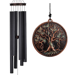 May include: A black wind chime with bronze accents and a circular pendant featuring a tree of life design. The wind chime has multiple black tubes and a decorative top. The tree of life pendant is bronze with green and brown details.