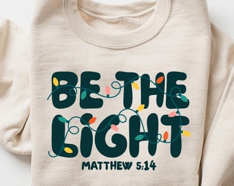 Felpa Be The Light, maglietta religiosa natalizia, regalo di festa cristiano, girocollo basato sulla fede, regalo di Natale, abbigliamento festivo