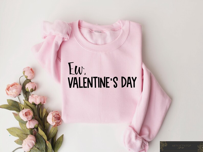 May include: Pink sweatshirt with the text "Ew. Valentine's Day" in black lettering.