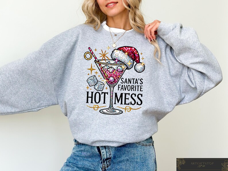 May include: Gray sweatshirt with a sparkly red and white martini glass design. The text on the sweatshirt reads "Santa's Favorite Hot Mess".