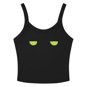 May include: A black sleeveless crop top featuring two small, symmetrical lime wedge graphics positioned horizontally across the chest area. The garment has a scoop neckline and wide shoulder straps, constructed from a solid black fabric.