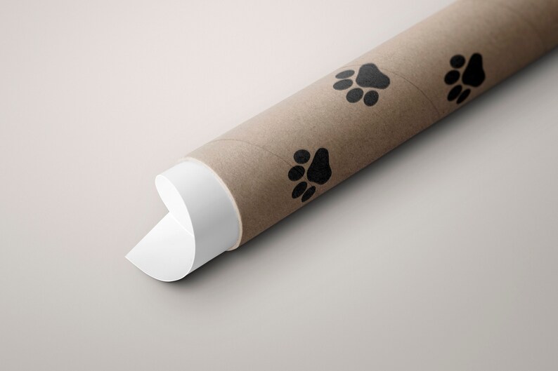 May include: A brown cardboard tube with a white end, decorated with black paw prints. The tube is rolled up and the white end is partially unrolled.