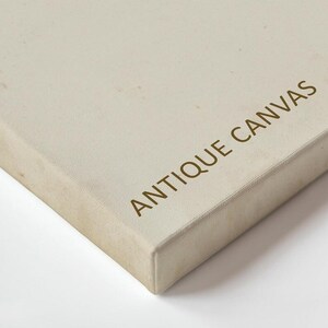 a close-up view of a beige canvas with the text "ANTIQUE CANVAS" printed on it.