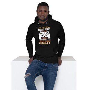 May include: Black hooded sweatshirt with a white graphic of a video game controller and the text "IF YOU CAN READ THIS WAS FORCED *TO PUT MY CONTROLLER DOWN AND RE-ENTER SOCIETY".