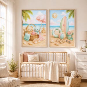 May include: Two framed wall art prints featuring beach scenes. The left print shows a teddy bear and bunny in a wicker basket with a pink umbrella. The right print displays a surfboard, beach ball, and swim ring under a smiling sun.