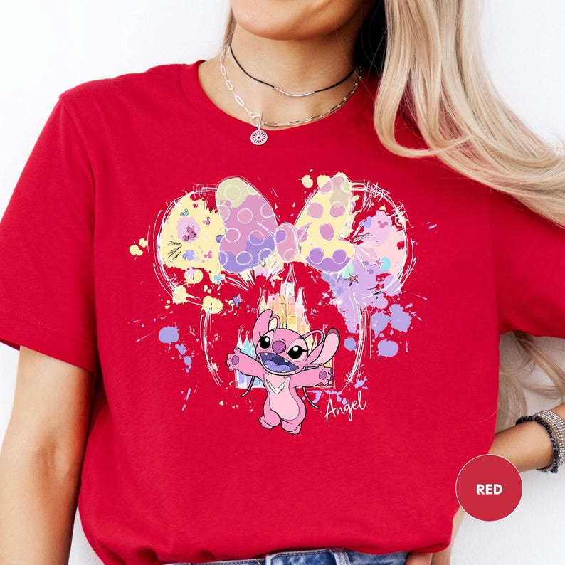 a woman wearing a red shirt with a cartoon character on it