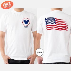 a man wearing a mickey mouse t - shirt with the american flag on it