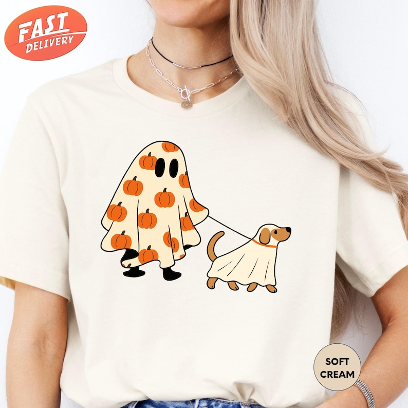 a woman wearing a t - shirt with a ghost and dog on it