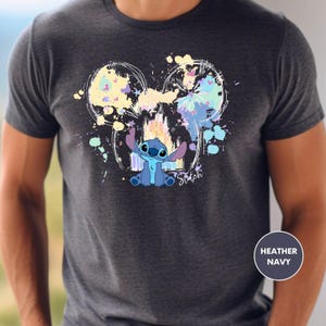 a man wearing a mickey mouse t - shirt