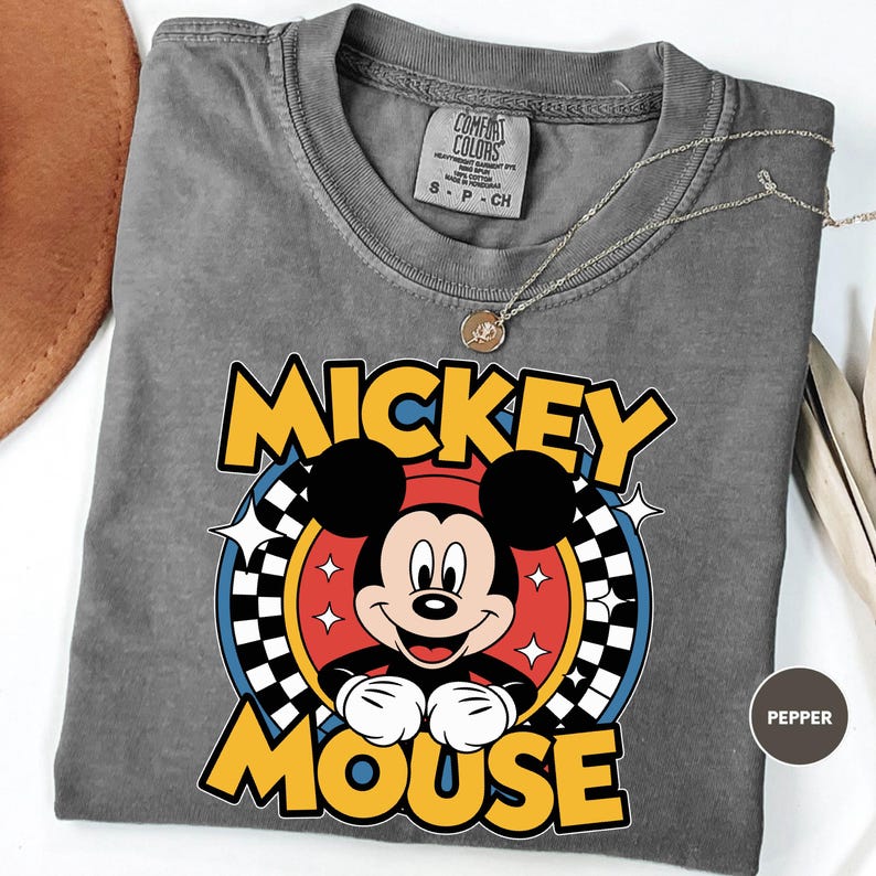 a mickey mouse tshirt with a hat on top of it