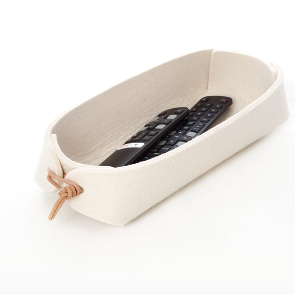 Remote control holder with leather ties in white and grey wool felt.