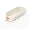 Remote control holder with leather ties in cream white and gray wool felt.