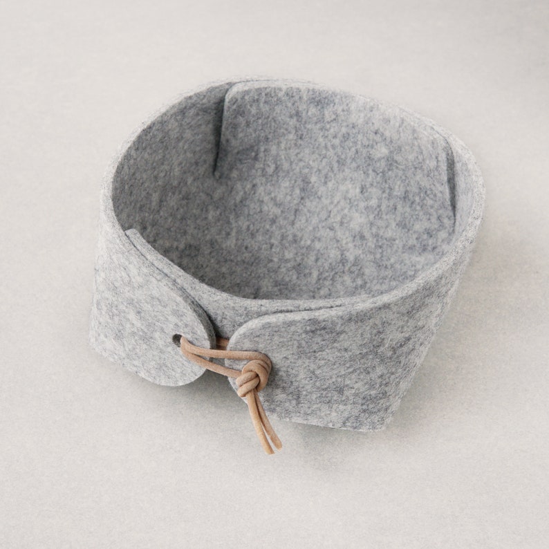 Small grey catch all or bedside tray in sturdy wool felt with leather toggles