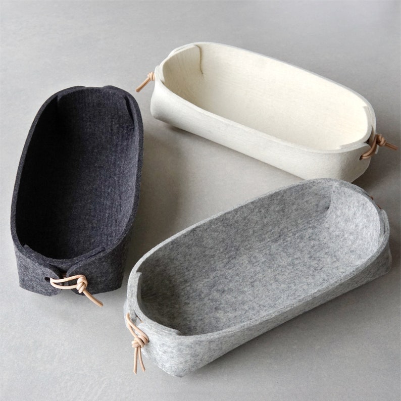 Three remote caddies in white, grey and charcoal from Skandinavious By Louise Vilmar