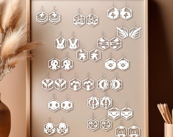 May include: A white frame with 20 white hexagonal earrings with different designs, including a skull, a bunny, a wing, and a symbol. The earrings are displayed on a beige wall.