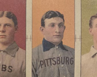 May include: A vintage baseball card strip featuring five portraits of baseball players. Each player is depicted in a sepia-toned image, wearing a baseball uniform. Team names like "CUBS", "PITTSBURG", and "CLEVELAND" are printed on the jerseys. The background colors vary.