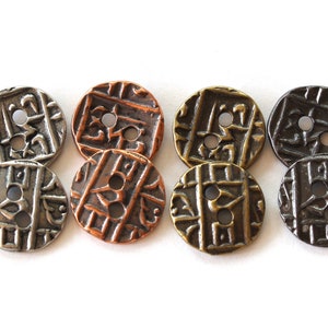 May include: Eight round buttons with an embossed geometric design. The buttons are in various metallic finishes, including silver, copper, bronze, and dark brown. Each button has two holes for sewing and a slightly raised surface.