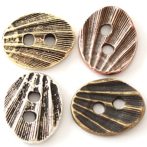 May include: Four decorative buttons in various metallic finishes: gold, copper, silver, and bronze. Each button has a textured, ridged surface and two holes for sewing. The buttons are oval-shaped and suitable for clothing or craft projects.