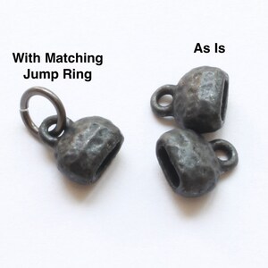May include: Three small, dark gray metal cup-shaped beads with a textured surface. One bead has a matching jump ring attached. The text "With Matching Jump Ring" and "As Is" are visible.