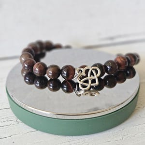 Natural stone beaded bracelet with silver charm