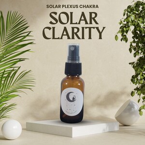 May include: A brown glass bottle with a black spray top and a white label with a crescent moon and an owl design. The label reads "Solar Clarity".