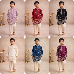 May include: A collection of six children's kurta pajama sets in various colors. Each set includes a long-sleeved kurta with embroidered floral detailing and matching off-white pajama pants. Colors include lavender, burgundy, black, cream, navy blue, and purple.