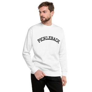 May include: White crew neck sweatshirt with black text that reads "PICKLEBACK" in an arched font.