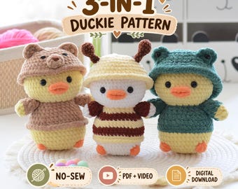 May include: Three crocheted duck figures with the text 3-IN-1 DUCKIE PATTERN, NO-SEW, PDF + VIDEO, and DIGITAL DOWNLOAD. The left duck wears a brown bear hood, the center duck has yellow antennae, and the right duck wears a green frog hood.